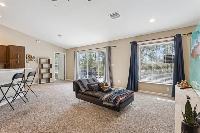 a living room with furniture and large windows