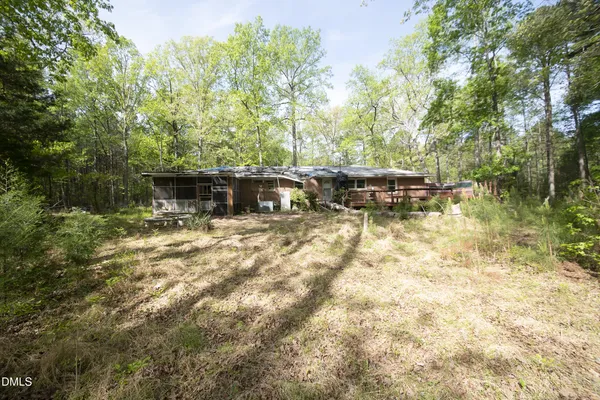 a backyard of a house with table and chairs