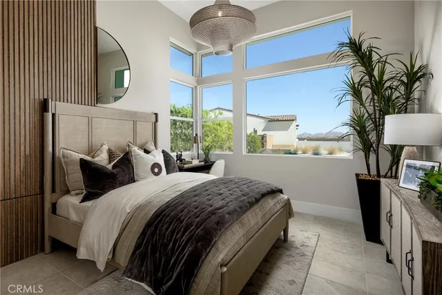 a bedroom with bed and a chandelier