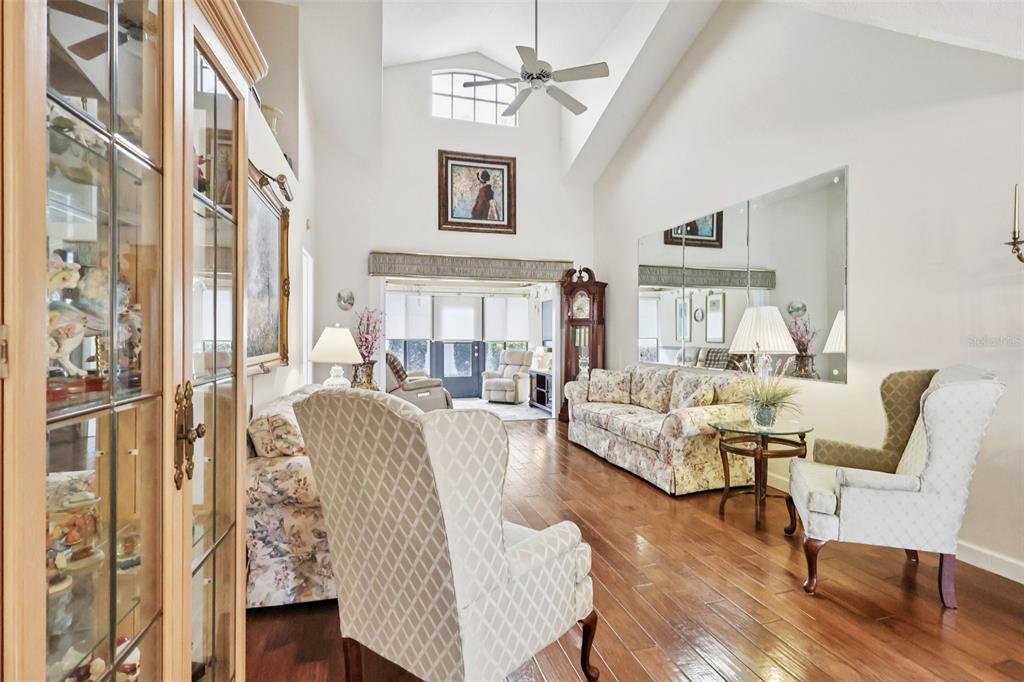 116 Baytree Boulevard Tavares, FL 32778 - Photo 13 of 47 a living room with furniture and a chandelier
