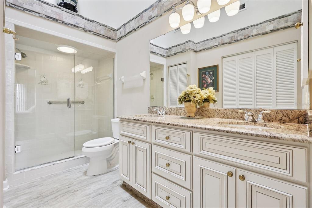 116 Baytree Boulevard Tavares, FL 32778 - Photo 18 of 47 a bathroom with a granite countertop sink a toilet and a mirror