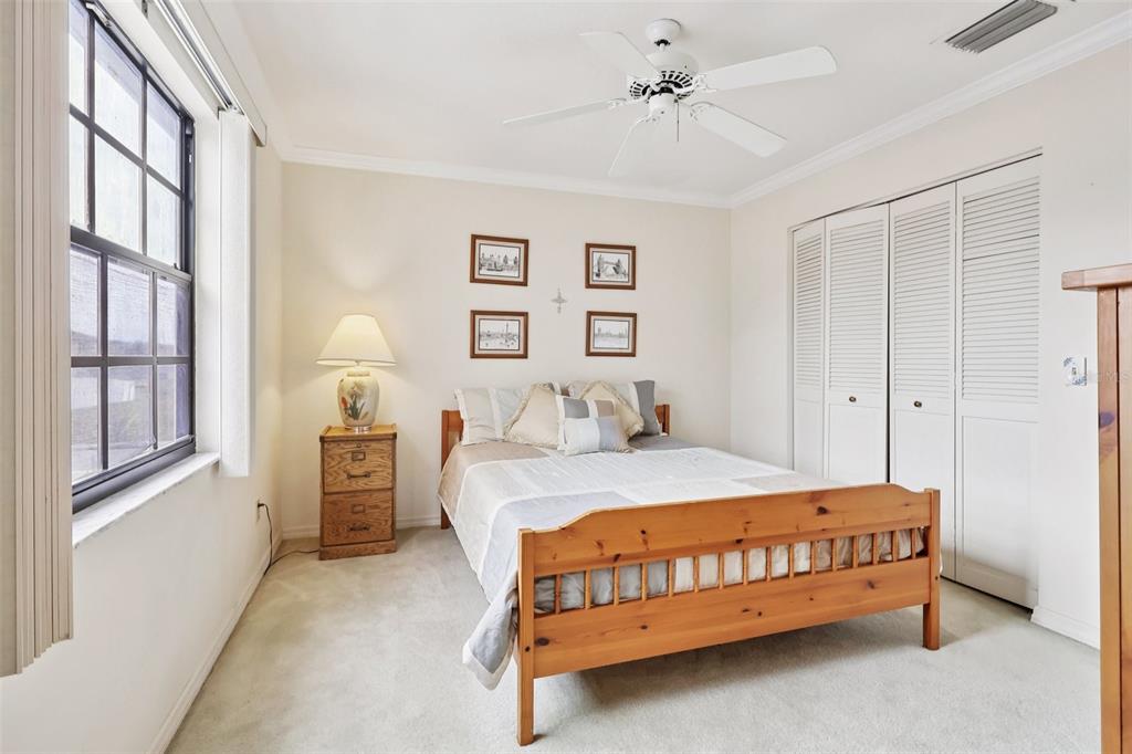 116 Baytree Boulevard Tavares, FL 32778 - Photo 22 of 47 a bedroom with a bed dresser and a window