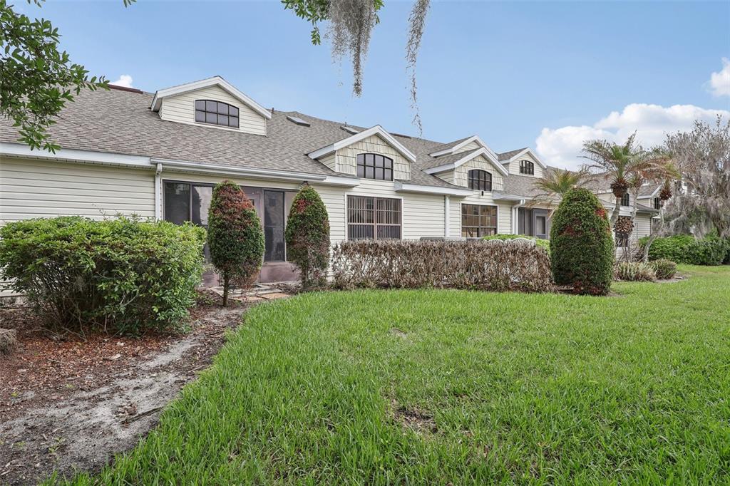 116 Baytree Boulevard Tavares, FL 32778 - Photo 26 of 47 a front view of a house with a garden