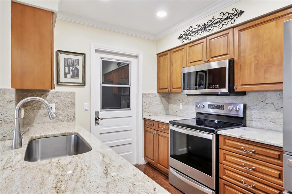 116 Baytree Boulevard Tavares, FL 32778 - Photo 5 of 47 a kitchen with granite countertop a sink and steel appliances