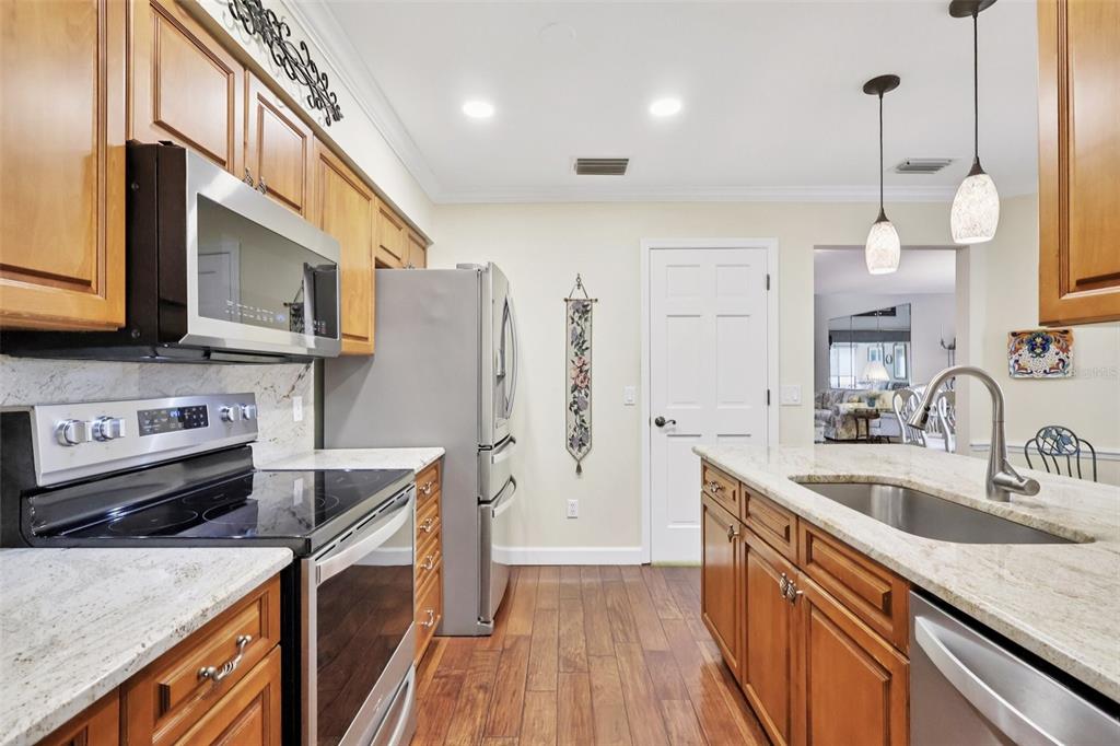 116 Baytree Boulevard Tavares, FL 32778 - Photo 6 of 47 a kitchen with stainless steel appliances granite countertop a sink stove and refrigerator