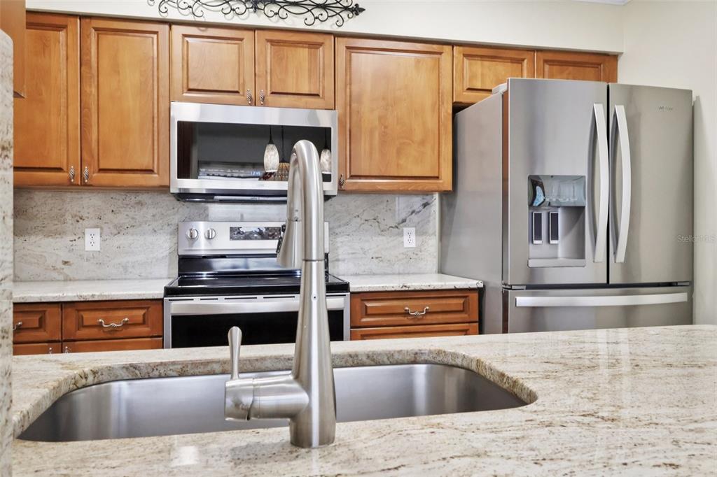 116 Baytree Boulevard Tavares, FL 32778 - Photo 7 of 47 a kitchen with granite countertop a refrigerator and a sink