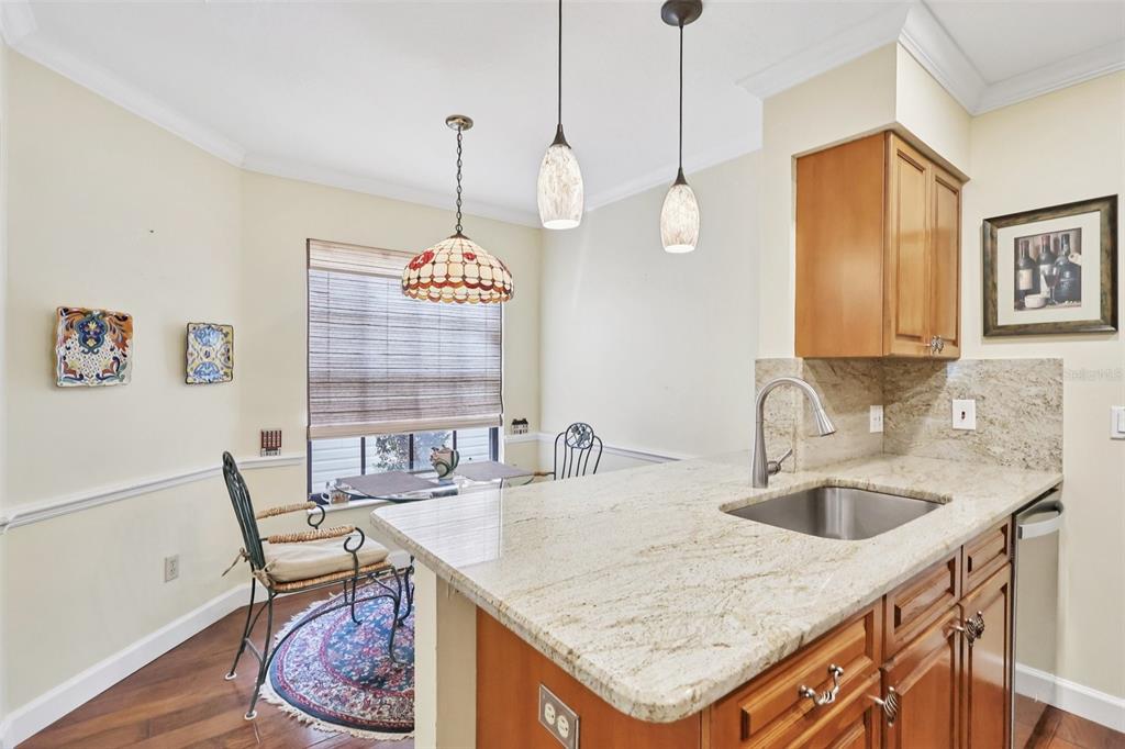 116 Baytree Boulevard Tavares, FL 32778 - Photo 8 of 47 a kitchen with a table chairs and a chandelier