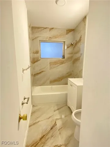 a bathroom with a toilet sink and bathtub