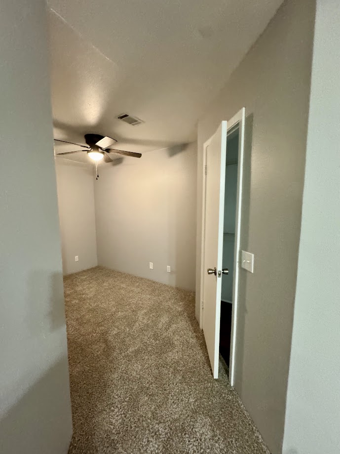 1305 West Villa Maria Road, Unit C107 Bryan, TX 77801 - Photo 15 of 19 Unfurnished room with carpet floors and ceiling fan