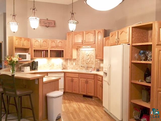 Open concept kitchen w/ ample cabinetry and peninsula breakfast bar.