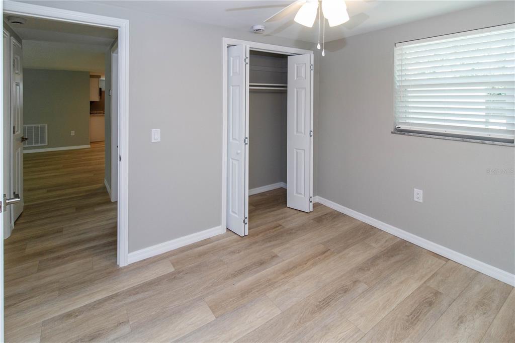 8313 Gulf Way Hudson, FL 34667 - Photo 15 of 27 wooden floor in an empty room with a window