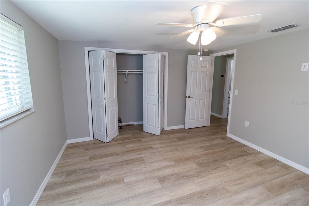 8313 Gulf Way Hudson, FL 34667 - Photo 16 of 27 wooden floor in an empty room with a window