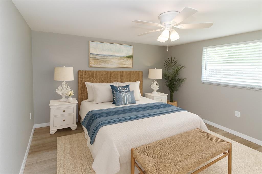 8313 Gulf Way Hudson, FL 34667 - Photo 17 of 27 a bedroom with a bed and a chandelier