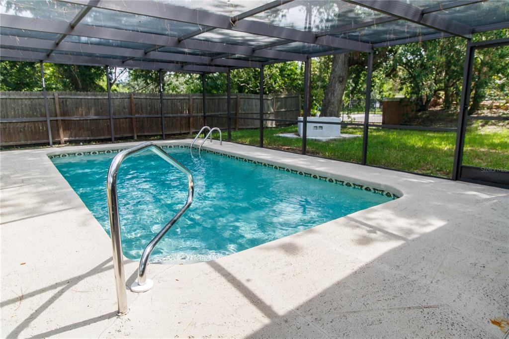 8313 Gulf Way Hudson, FL 34667 - Photo 20 of 27 a view of a backyard with a swimming pool
