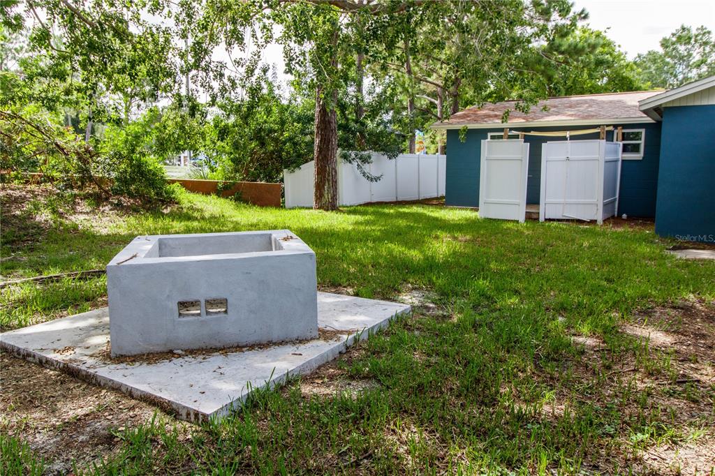 8313 Gulf Way Hudson, FL 34667 - Photo 21 of 27 a view of a tiny house with a yard and a large tree