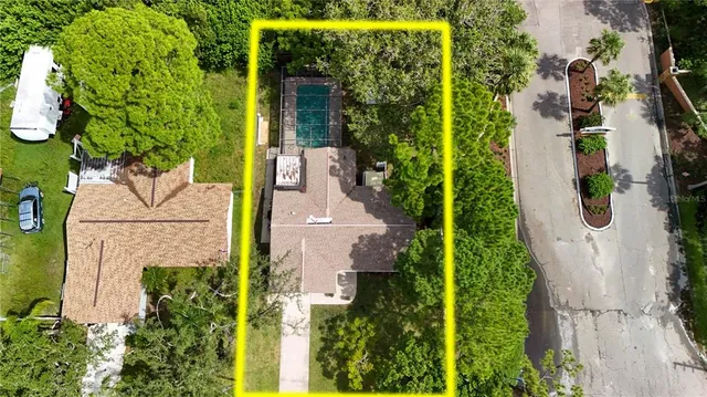 an aerial view of a house with swimming pool and garden