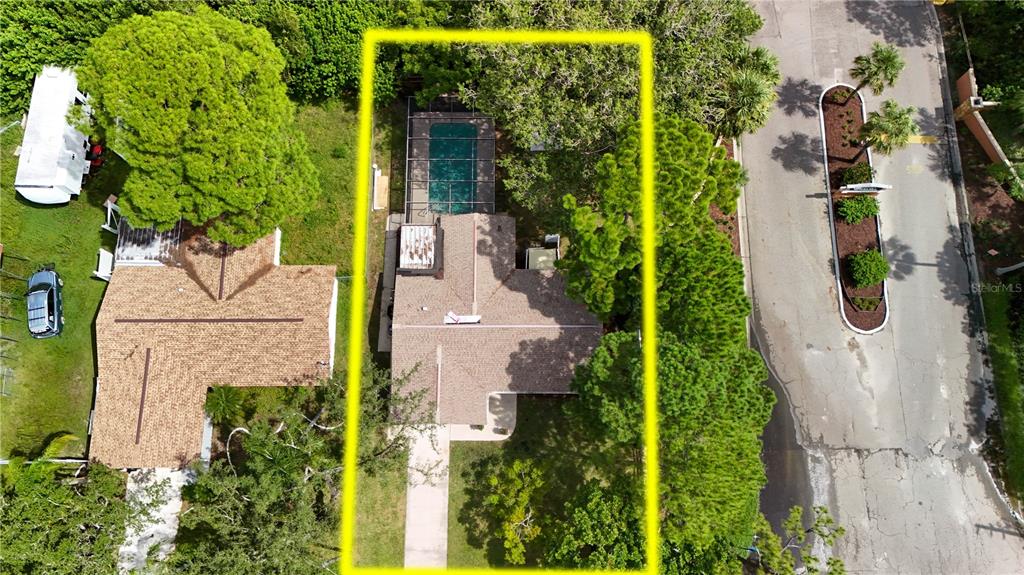 8313 Gulf Way Hudson, FL 34667 - Photo 3 of 27 an aerial view of a house with swimming pool and garden