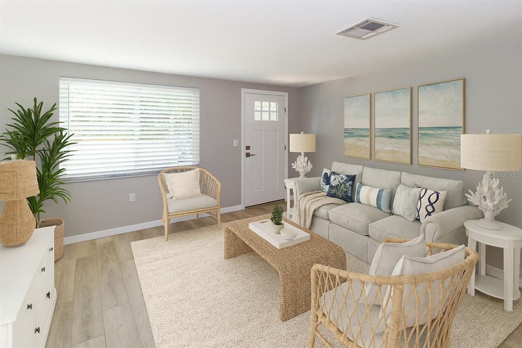 8313 Gulf Way Hudson, FL 34667 - Photo 8 of 27 a living room with furniture and a large window