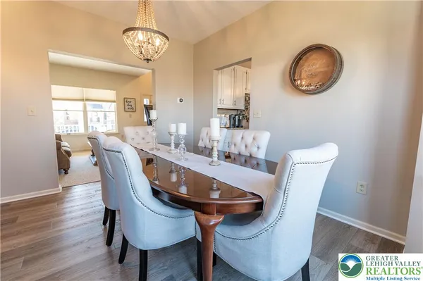 a dining room with furniture a window and wooden floor