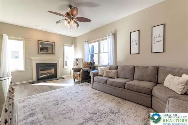 a living room with furniture a window and a fireplace