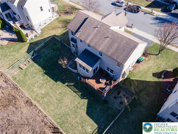 an aerial view of a house with a yard