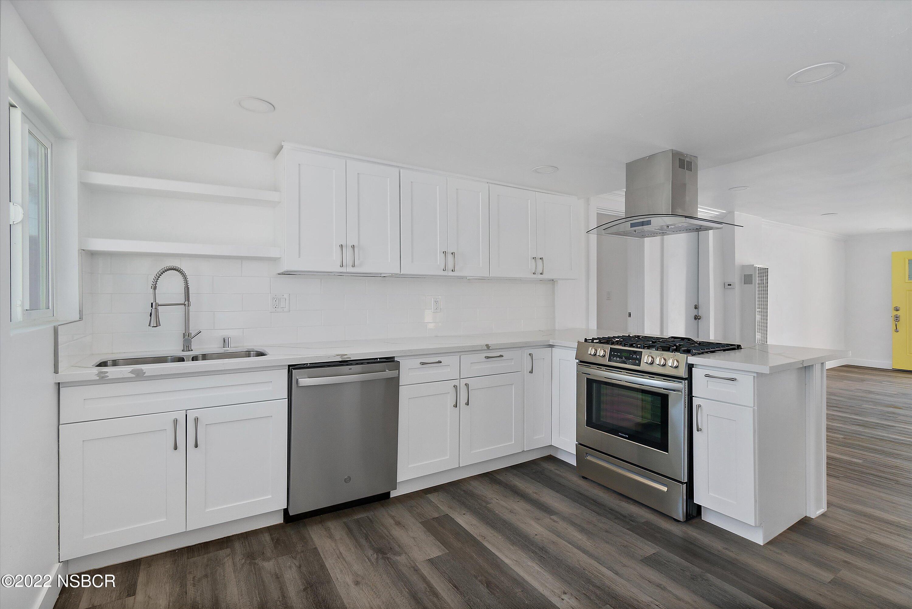 455 Longbranch Avenue Grover Beach, CA 93433 - Photo 12 of 23 a kitchen with cabinets stainless steel appliances and wooden floor