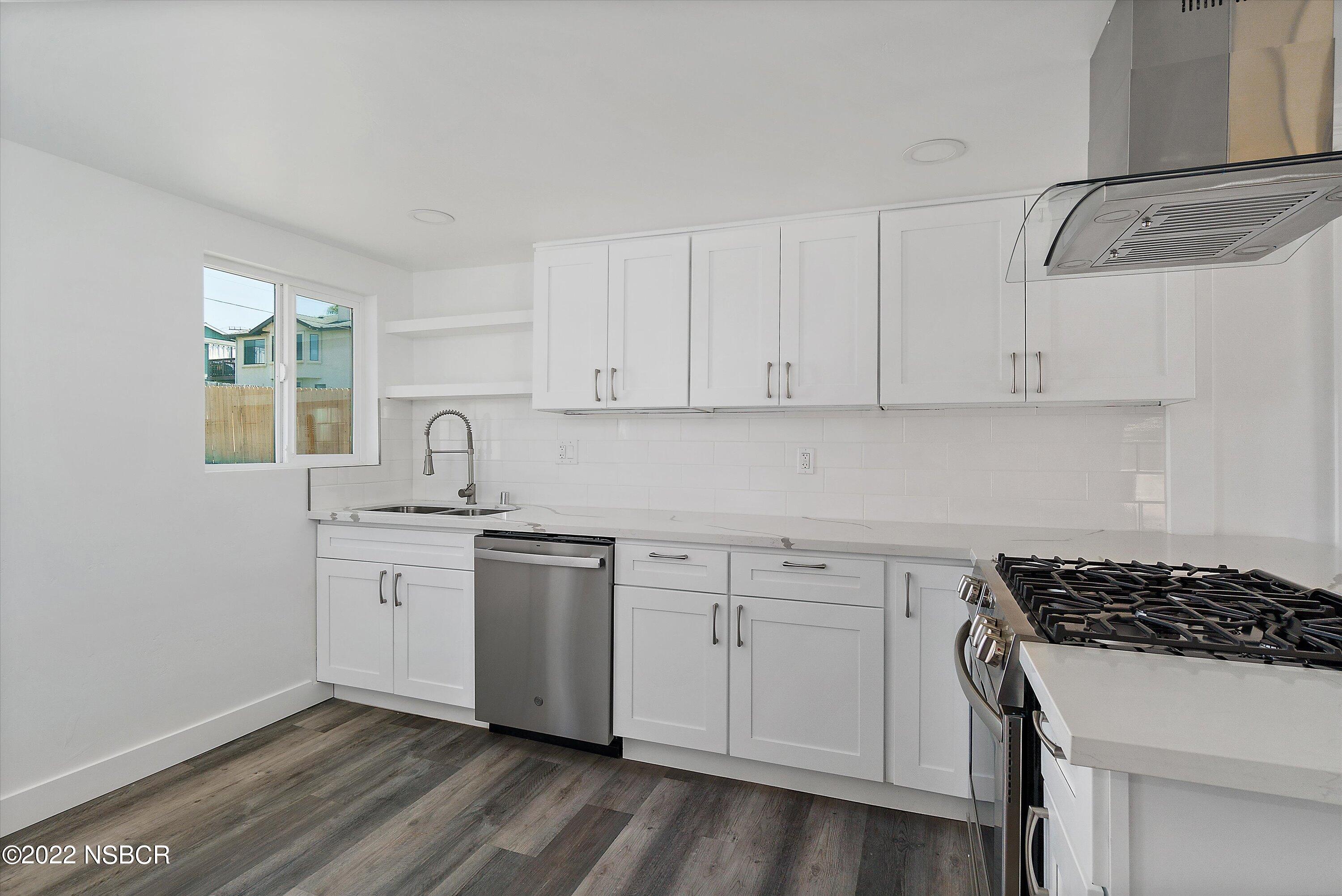 455 Longbranch Avenue Grover Beach, CA 93433 - Photo 13 of 23 a kitchen with white cabinets and appliances