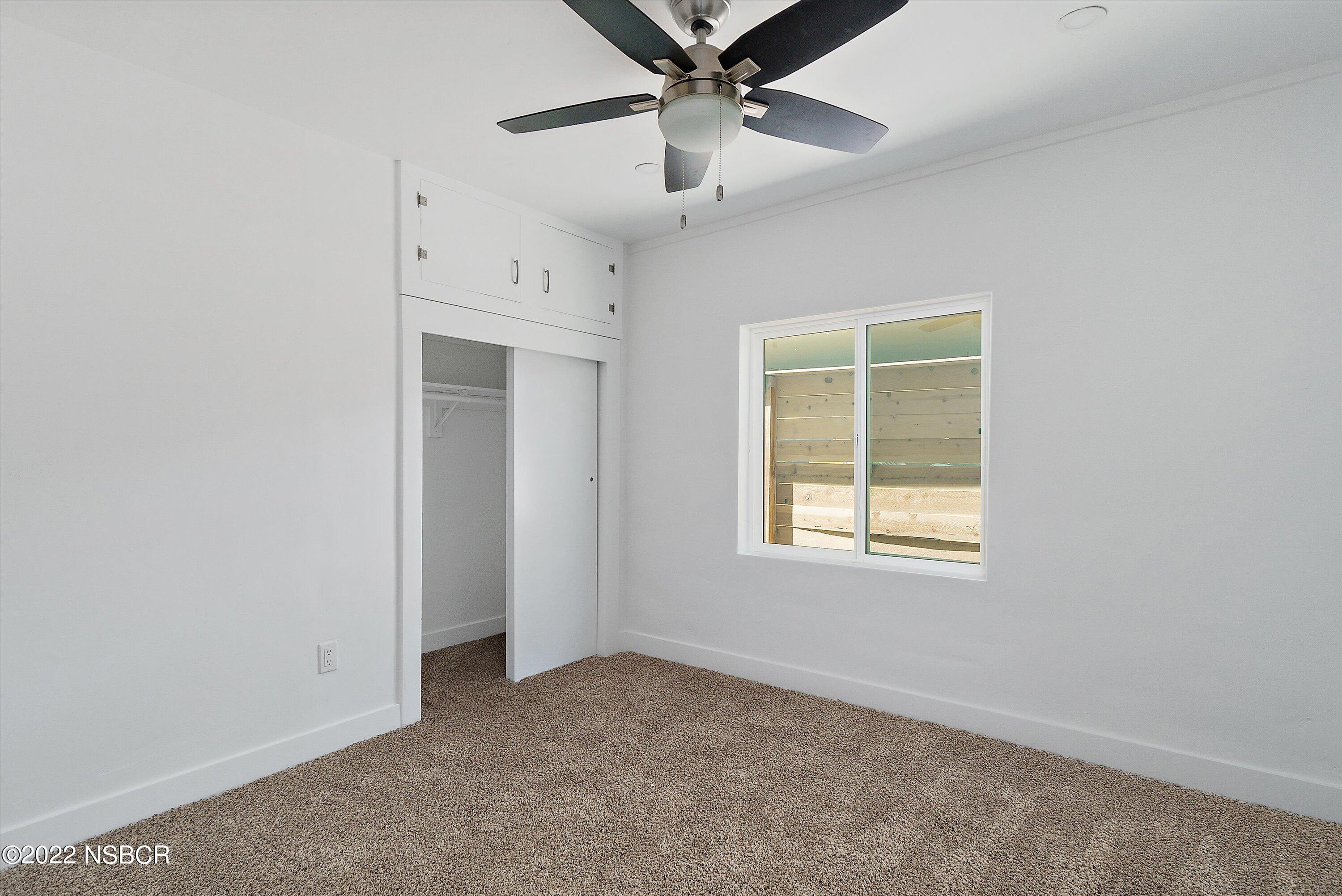 455 Longbranch Avenue Grover Beach, CA 93433 - Photo 17 of 23 an empty room with a window and a fan