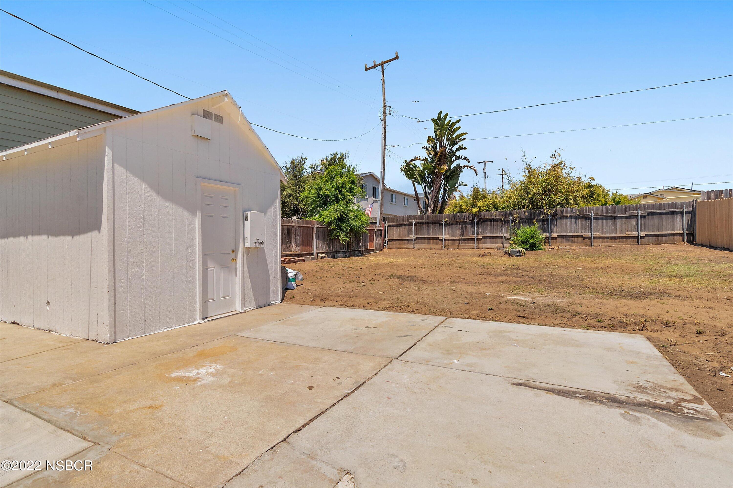 455 Longbranch Avenue Grover Beach, CA 93433 - Photo 21 of 23 a view of a house with a yard and potted plants