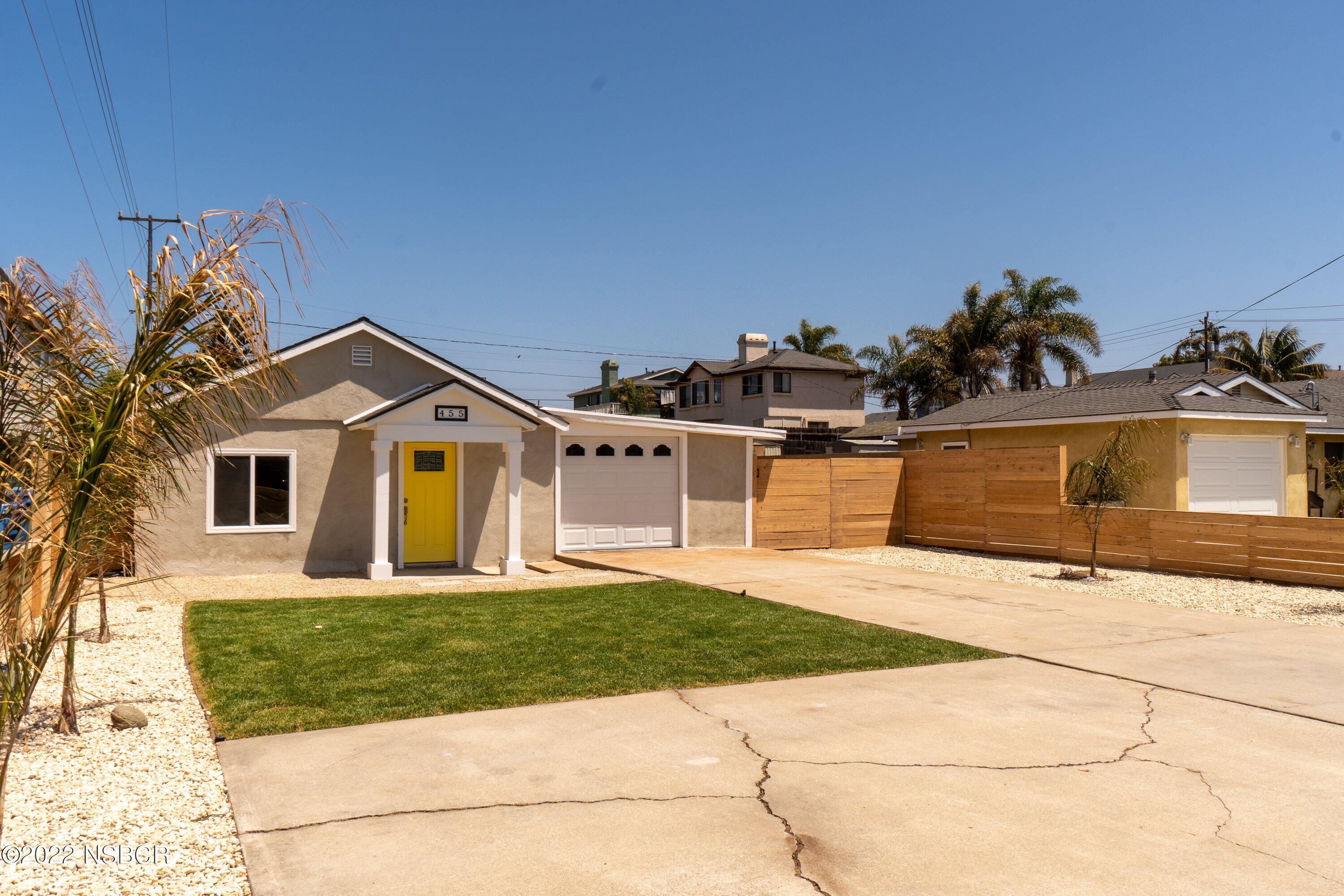 455 Longbranch Avenue Grover Beach, CA 93433 - Photo 3 of 23 a front view of a house with a yard