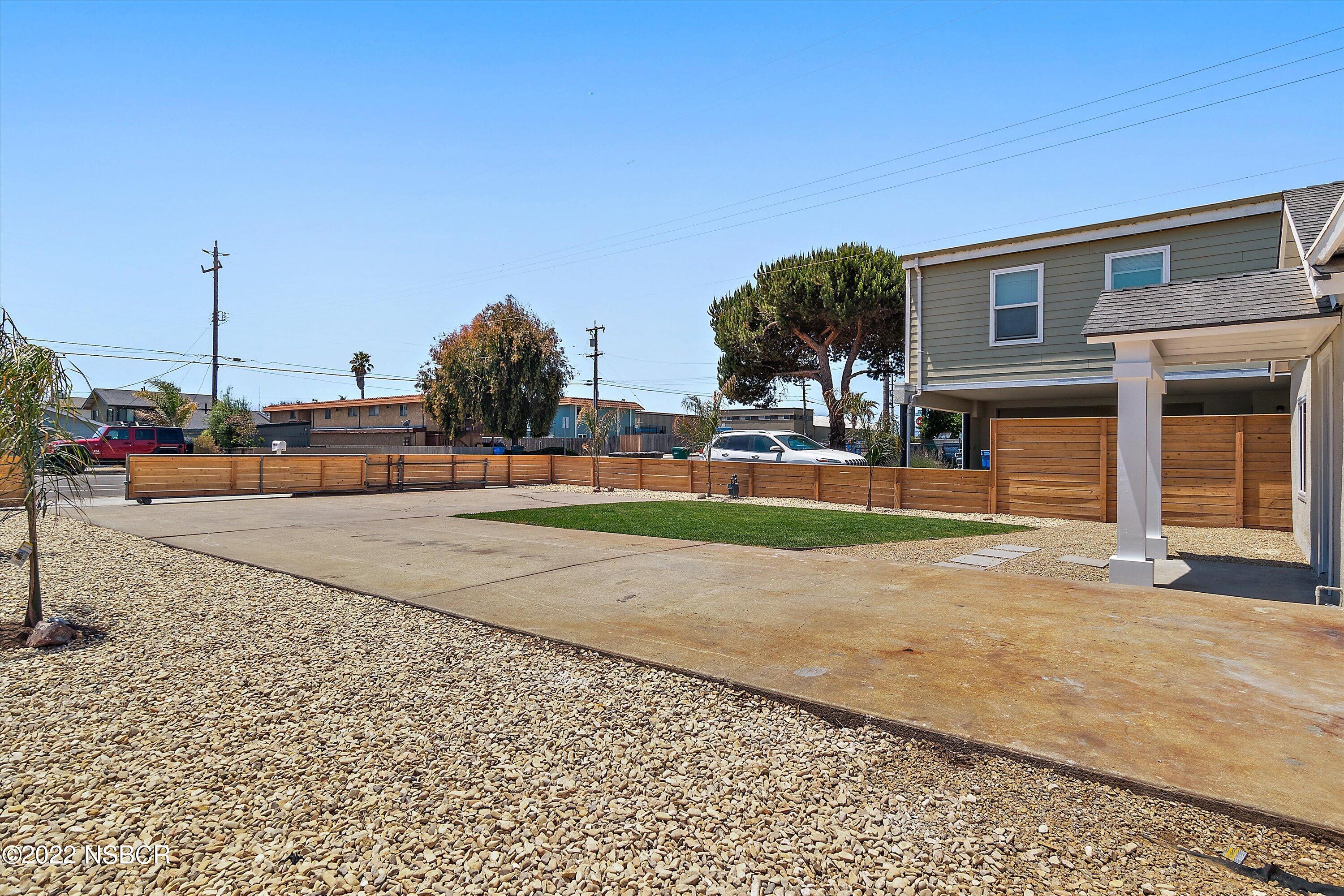 455 Longbranch Avenue Grover Beach, CA 93433 - Photo 7 of 23 a view of a street with houses on both side of it