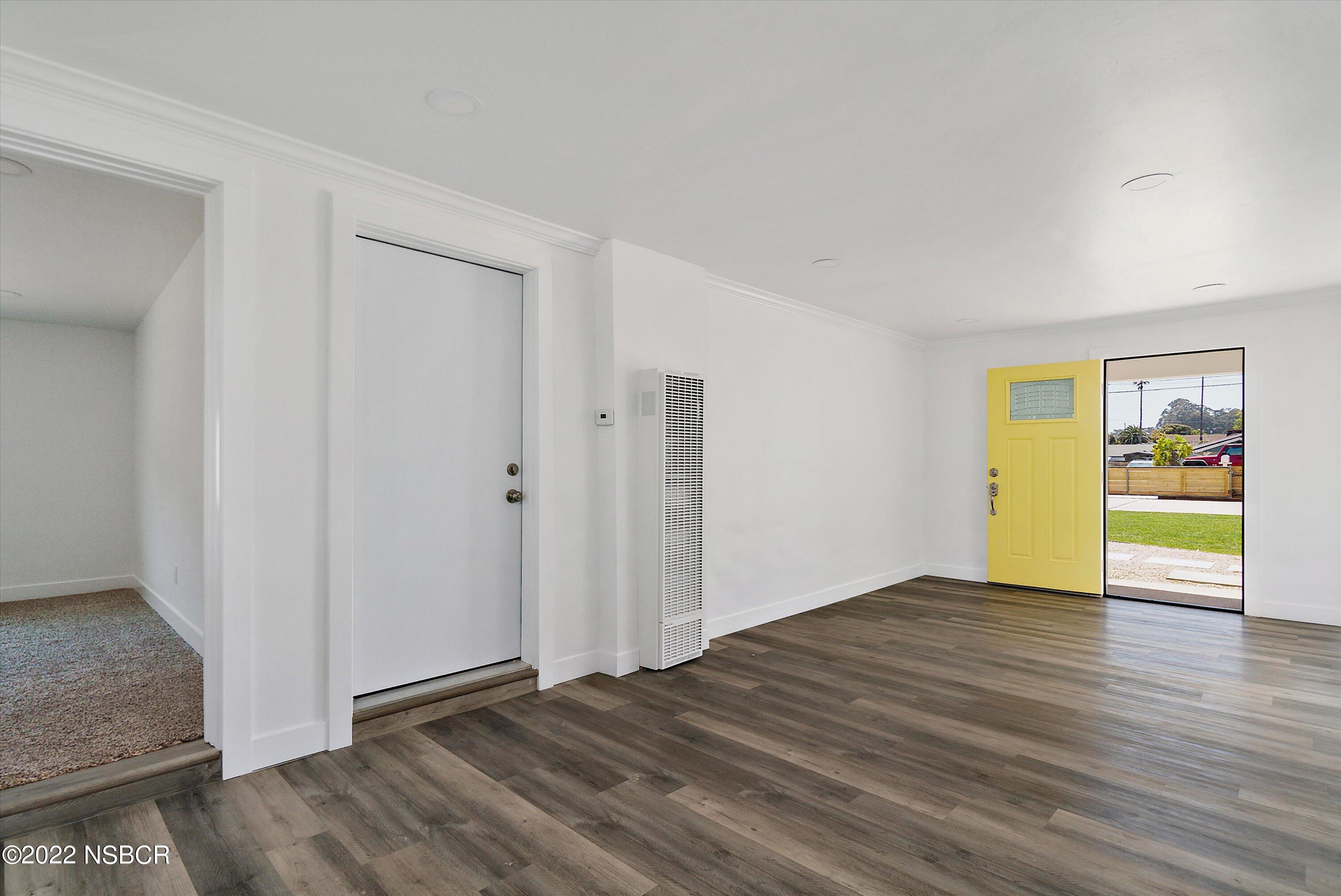455 Longbranch Avenue Grover Beach, CA 93433 - Photo 8 of 23 a view of an empty room with wooden floor and a window