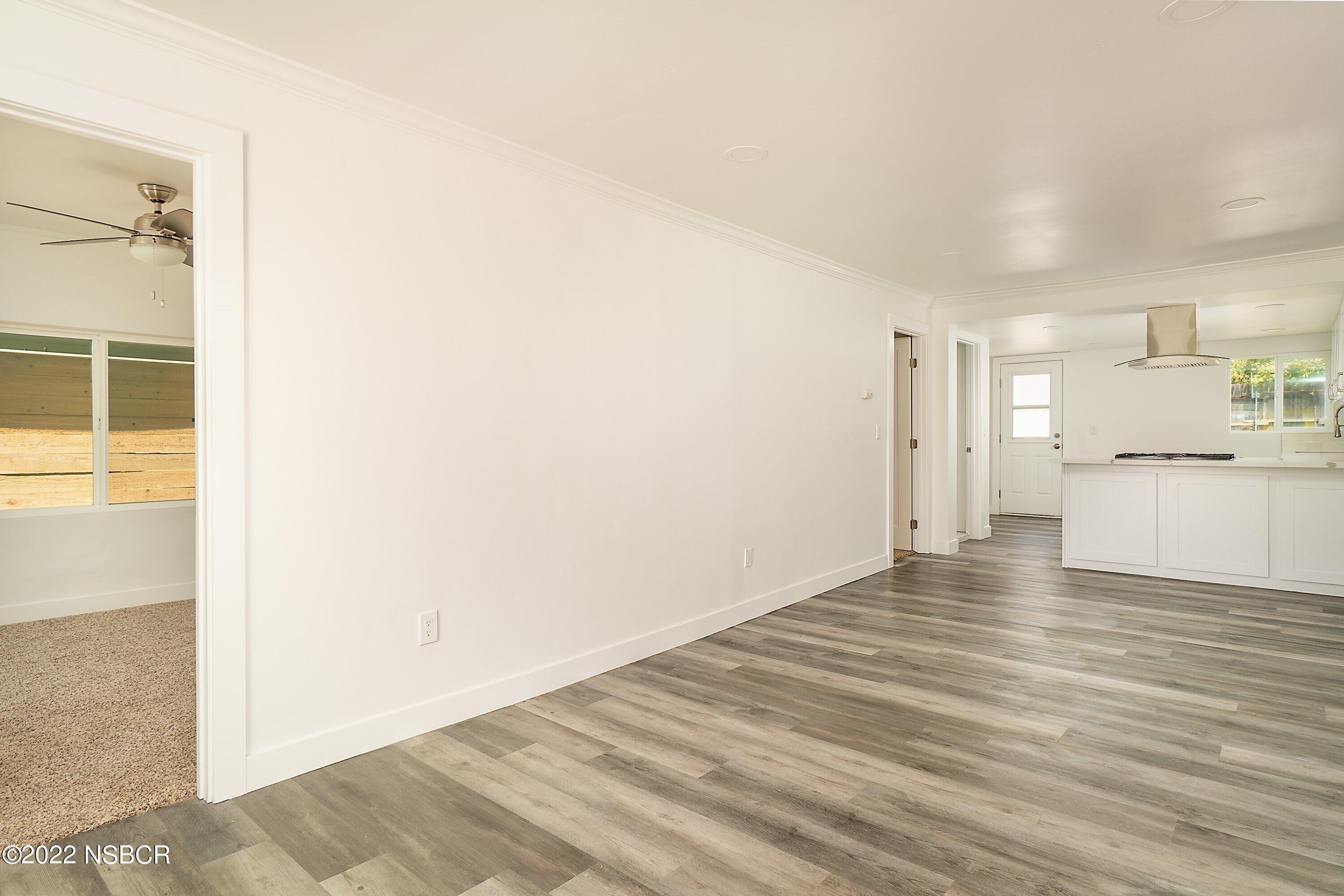 455 Longbranch Avenue Grover Beach, CA 93433 - Photo 9 of 23 a view of a kitchen with a sink and a refrigerator