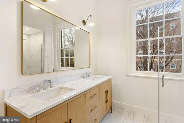 a bathroom with a sink vanity and a mirror