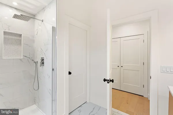 a bathroom with a granite countertop shower