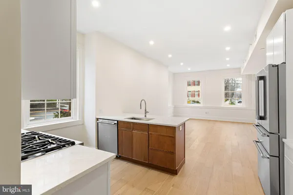 a view of a kitchen with a sink and cabinets