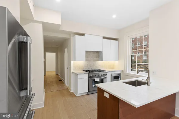 a kitchen with a stove a refrigerator and a stove