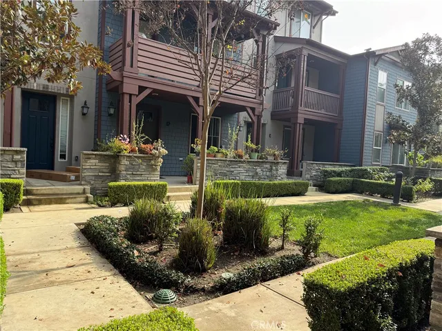 a backyard of a house with barbeque oven table and chairs