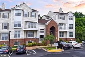 a front view of a residential apartment building with parking space
