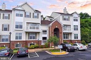 46891 Eaton Terrace, Unit 101 Sterling, VA 20164 - Photo 1 of 41 a front view of a residential apartment building with parking space