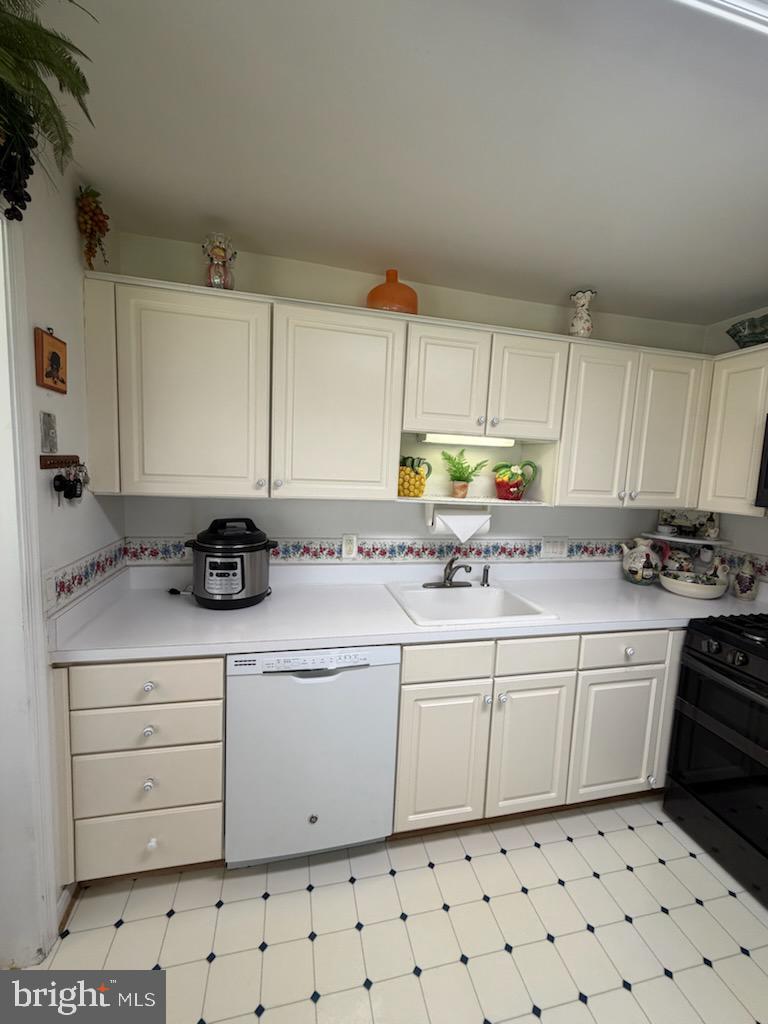 46891 Eaton Terrace, Unit 101 Sterling, VA 20164 - Photo 12 of 41 a kitchen with granite countertop a sink window and cabinets