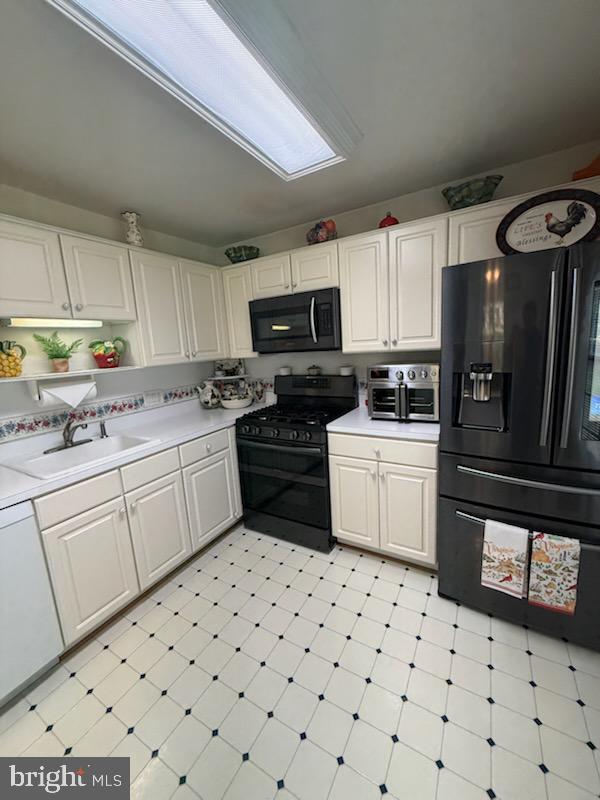 46891 Eaton Terrace, Unit 101 Sterling, VA 20164 - Photo 13 of 41 a kitchen with granite countertop a sink a stove a microwave and cabinets