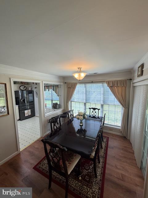 46891 Eaton Terrace, Unit 101 Sterling, VA 20164 - Photo 16 of 41 a view of a dining room with furniture and wooden floor
