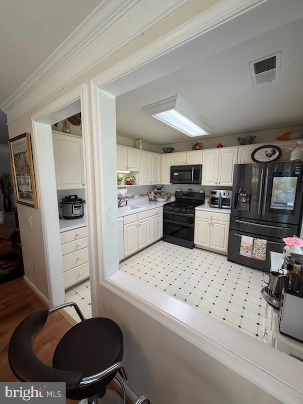46891 Eaton Terrace, Unit 101 Sterling, VA 20164 - Photo 17 of 41 a kitchen with white cabinets and appliances