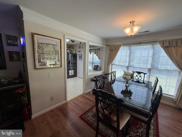 46891 Eaton Terrace, Unit 101 Sterling, VA 20164 - Photo 24 of 41 a view of a dining room with furniture and wooden floor