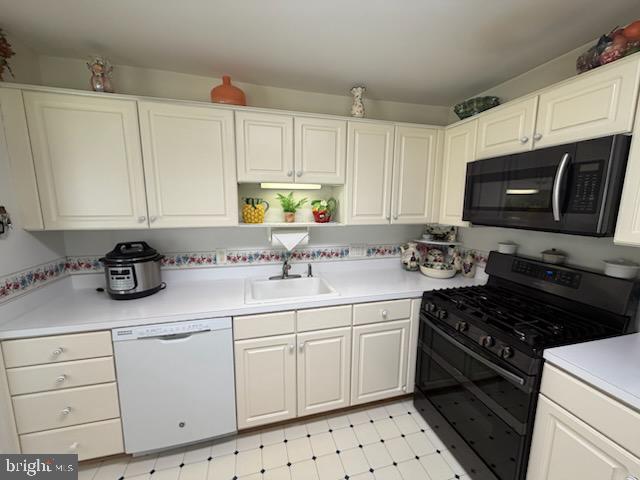 46891 Eaton Terrace, Unit 101 Sterling, VA 20164 - Photo 27 of 41 a kitchen with granite countertop a sink a stove and cabinets