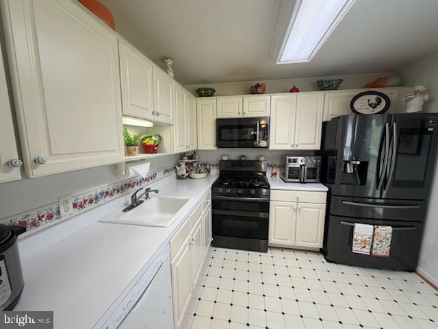 46891 Eaton Terrace, Unit 101 Sterling, VA 20164 - Photo 29 of 41 a kitchen with a sink a stove and refrigerator