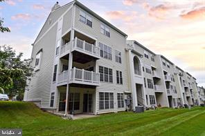 46891 Eaton Terrace, Unit 101 Sterling, VA 20164 - Photo 3 of 41 a front view of a building with a yard