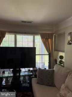 46891 Eaton Terrace, Unit 101 Sterling, VA 20164 - Photo 35 of 41 a living room with furniture and a flat screen tv