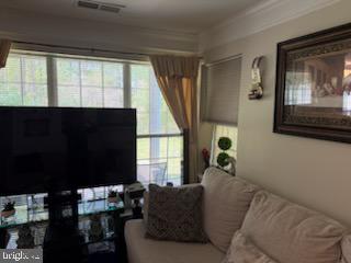 46891 Eaton Terrace, Unit 101 Sterling, VA 20164 - Photo 36 of 41 a living room with furniture and a window
